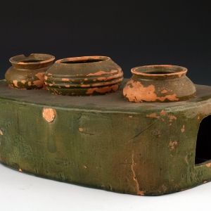 Pottery stove in green glaze