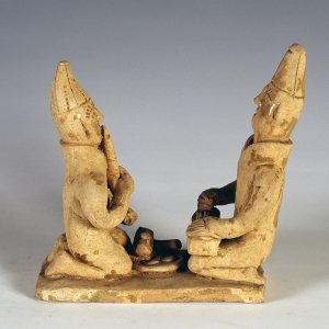 A pair of figurines playing music
